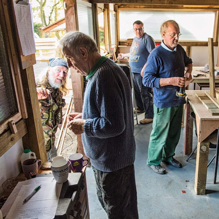 Men's shed with men working